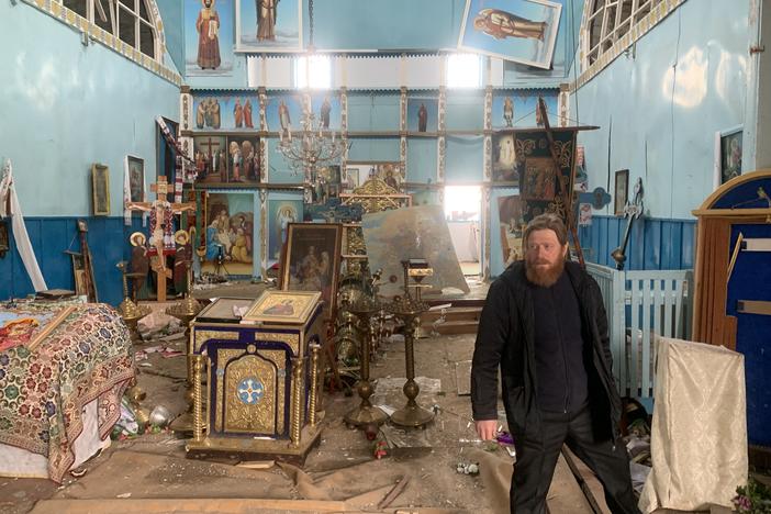 Father Oleksandr Yarmolchyk stands inside the demolished nave of his Orthodox church in Peremoha, Ukraine on April 17. He says the Russians bombed his church and held him against his will.