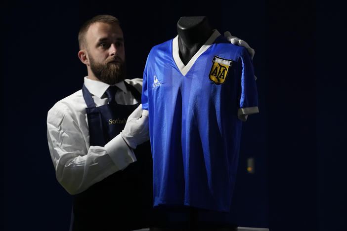 The Argentina football shirt worn by Diego Maradona in the 1986 Mexico World Cup quarterfinal soccer match between Argentina and England, is displayed for photographs at Sotheby's auction house, in London, on April 20. The shirt worn by Maradona when he scored the controversial "Hand of God" goal has sold for $9.3 million.