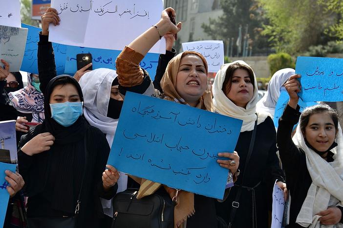 Afghan girls and women and girls protest in front of the Ministry of Education in Kabul on March 26, 2022, demanding that high schools be reopened for girls.