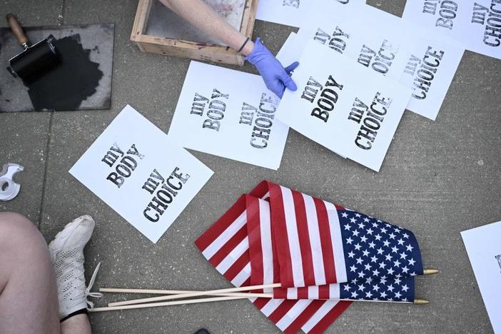 Pro-choice demonstrators make signs Tuesday in front of the U.S. Supreme Court in Washington.