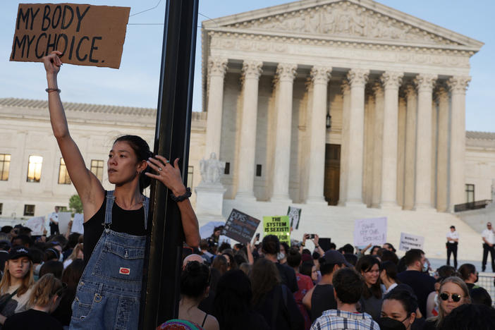 A person holds a sign during a rally in front of the Supreme Court on Tuesday in response to its leaked draft decision to overturn <em>Roe v. Wade</em>.