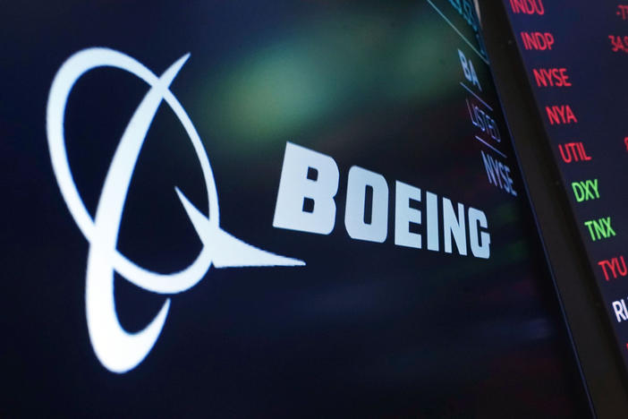 The logo for Boeing appears on a screen above a trading post on the floor of the New York Stock Exchange on July 13, 2021. The company said Thursday that it will move its headquarters from Chicago to Arlington, Va.