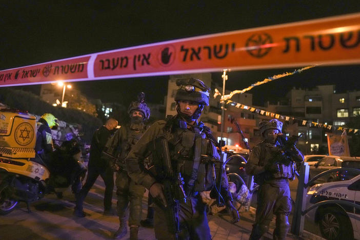 Israeli forces secure the area of a stabbing attack in the town of Elad, on Thursday. Israeli medics say at least three people were killed.