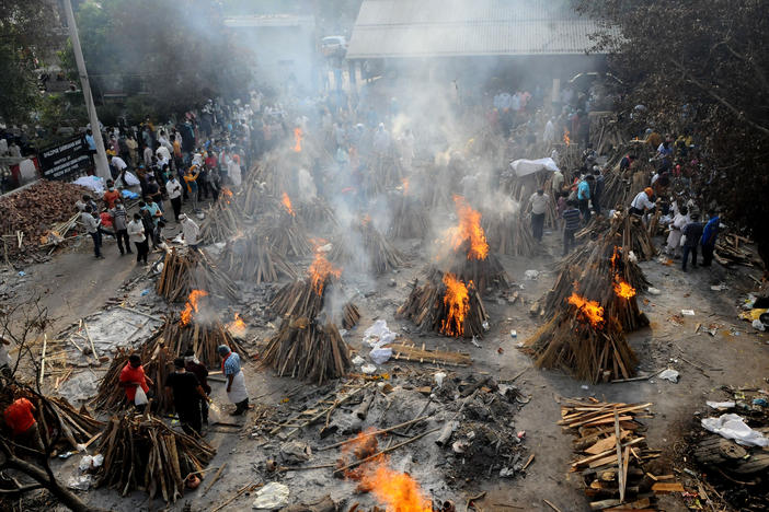 A mass cremation of people who died from from COVID-19 in New Delhi, India on April 28, 2021. A new WHO report on "excess deaths" compares their calculations with official numbers and finds millions more people died that the government-provided global total, with India a key example. India disputes the WHO finding and stands by its lower numbers.