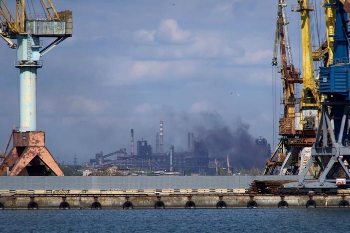 Smoke rises above the Azovstal steel plant in Mariupol on April 29, amid Russia's invasion of Ukraine. Hundreds of civilians are still trapped inside, officials say.