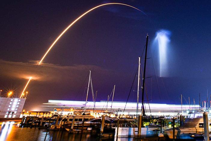 A SpaceX Falcon 9 rocket lifted off from pad 39A at Kennedy Space Center early Friday morning. This time exposure image captured the 'space jellyfish" effect of the contrail viewed from Port Canaveral Marine. The white streak on the horizon was caused by light from a cruise ship coming into port.