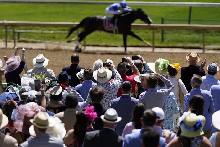 Fans cheers during race five before the 147th running of the Kentucky Derby at Churchill Downs in Louisville, Ky.