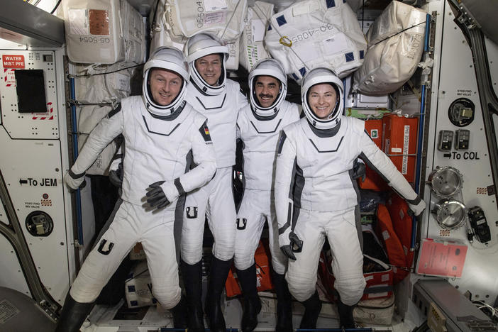 In this photo made available by NASA, commercial crew astronauts, from left, European Space Agency astronaut Matthias Maurer, and NASA astronauts Tom Marshburn, Raja Chari, and Kayla Barron, pose for a photo in their Dragon spacesuits during a fit check aboard the International Space Station's Harmony module on April 21, 2022.