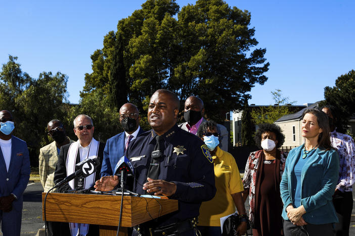 LeRonne L. Armstrong, Chief of Police, Oakland Police Department, stands near Oakland Mayor Libby Schaaf, right, as he delivers remarks during a press conference in Oakland, Calif.