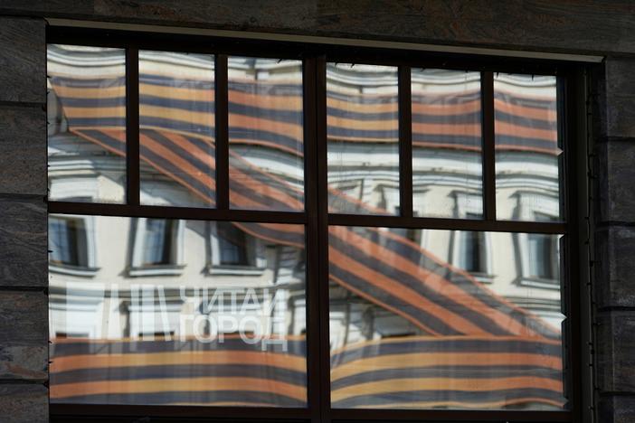 A huge letter Z, which has become a symbol of the Russian military, is reflected in an office building in a street in Moscow, Russia, Friday, May 6, 2022.