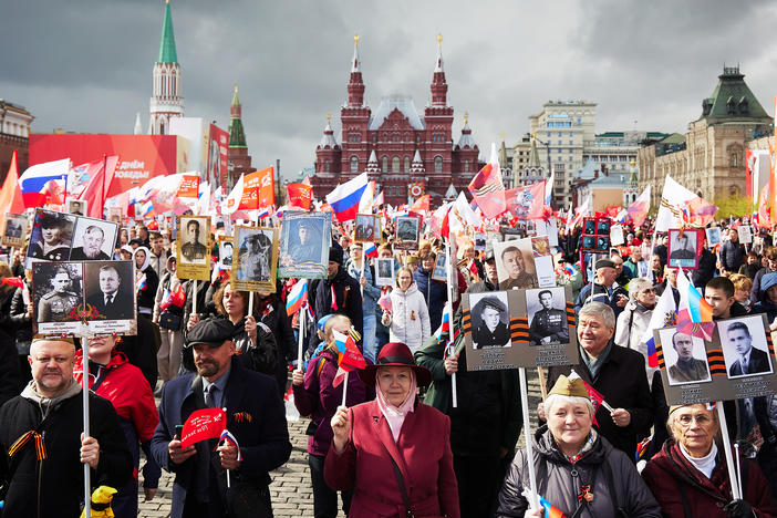 People carry portraits of their relatives, including World War II soldiers, as they take part in the Immortal Regiment march on Red Square on Monday in Moscow. The event is part of Russia's Victory Day, celebrating the Soviet Union's defeat of Nazi Germany, which took on new importance with the invasion of Ukraine.