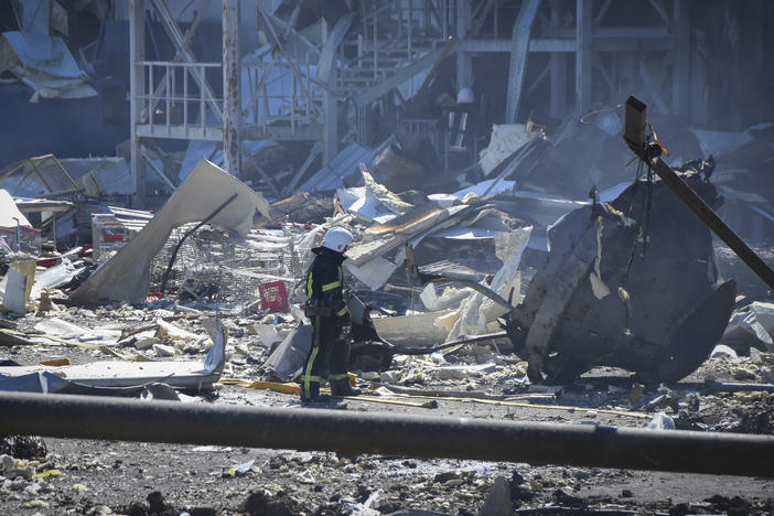 An Ukrainian firefighter works near a destroyed building on the outskirts of Odesa, Ukraine, on Tuesday. The Ukrainian military said Russian forces fired seven missiles a day earlier from the air at the crucial Black Sea port of Odesa, hitting a shopping center and a warehouse.