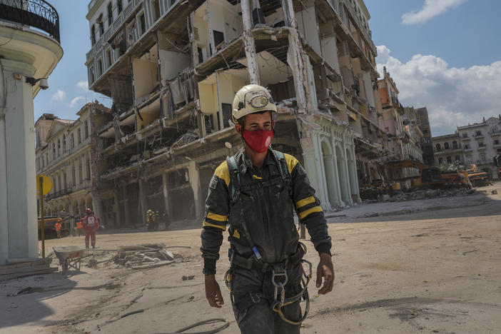 A rescue worker walks away from the destroyed five-star Hotel Saratoga on Tuesday after searching through the rubble days after a deadly explosion in Old Havana, Cuba.