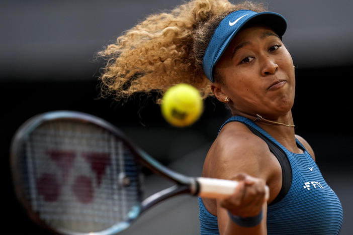 Naomi Osaka of Japan returns the ball against Sara Sorribes Tormo of Spain during their match at the Mutua Madrid Open tennis tournament in Madrid, Spain, on May 1, 2022.