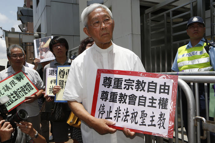 Hong Kong's outspoken cardinal Joseph Zen, center, and other religious protesters hold placards with "Respects religious freedom" written on them during a demonstration outside the China Liaison Office in Hong Kong, Wednesday, July 11, 2012.