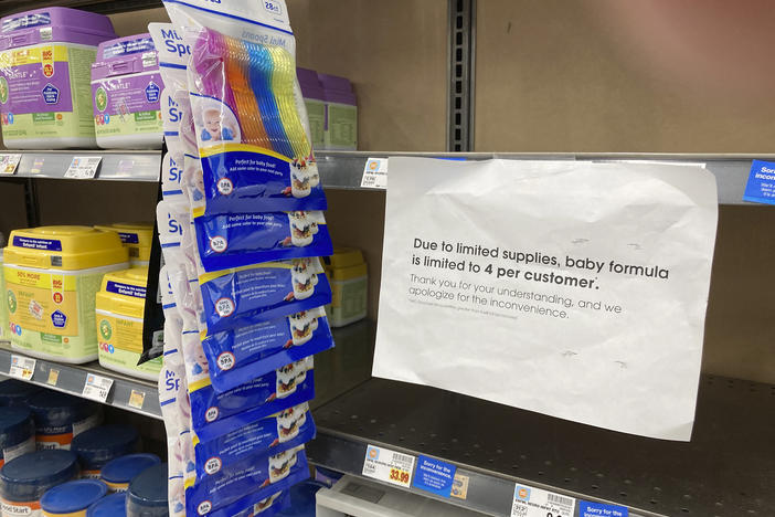 A sign telling consumers of limits on the purchase of baby formula hangs on the edge of an empty shelf for the product in a King Soopers grocery store, Wednesday, in Denver.