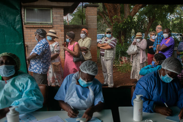 People line up to get the Sinopharm vaccine in Harare, Zimbabwe. World leaders promised to speed up vaccine distribution to low- and middle-income countries at the White House's second Global COVID-19 Summit on May 12.