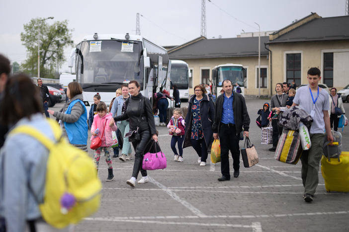 Refugees from war-torn regions of Ukraine board a coach to Warsaw at a coach station on Saturday in Lviv, Ukraine. A U.N. agency estimates that nearly 5 million jobs have been lost in Ukraine since Russia first invaded in late February.