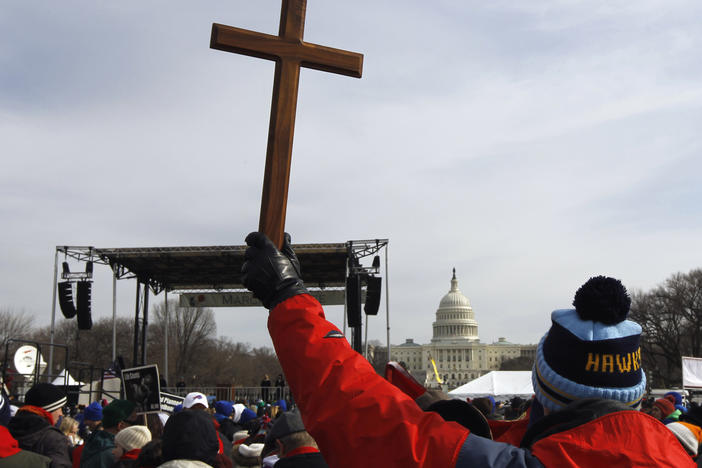 A man holds a cross during an anti-abortion rally on the National Mall in Washington on Jan. 24, 2011.