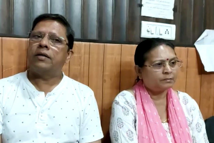 This image from video shows Sanjeev Ranjan Prasad, a 61-year-old retired government officer, and his wife Sadhana Prasad as they wait at a lawyer's chamber in Haridwar, India, on Thursday. The couple has sued their son and daughter-in-law, demanding a grandchild within a year or compensation of 50 million rupees ($675,675).
