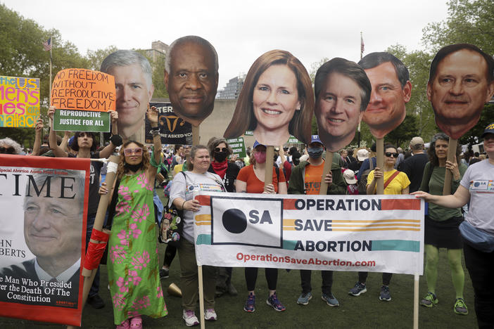 Protesters hold up signs during an abortion rights demonstration Saturday in New York City.