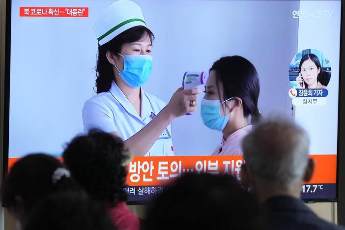People watch a TV screen showing a news report about the COVID-19 outbreak in North Korea, at a train station in Seoul, South Korea, Saturday, May 14, 2022. North Korea on Saturday reported 21 new deaths and 174,440 more people with fever symptoms as the country scrambles to slow the spread of COVID-19 across its unvaccinated population.