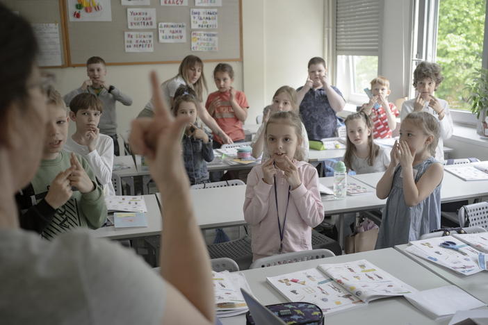Students interact with a teacher during a lesson at Poland's Warsaw Ukrainian School, on Wednesday, May 11, 2022.