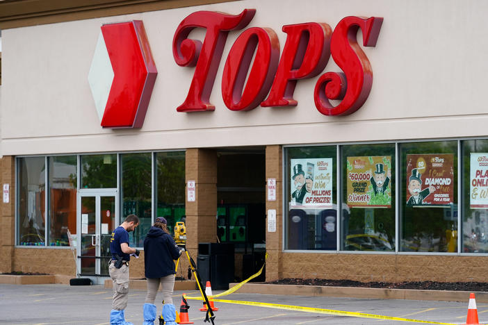 Investigators work the scene of a shooting at a supermarket in Buffalo, N.Y. on Monday.