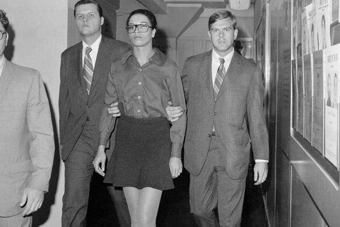 Angela Davis is escorted by two FBI agents after her arrest in New York on Oct. 13, 1970. She was taken from FBI headquarters to the Women's House of Detention.