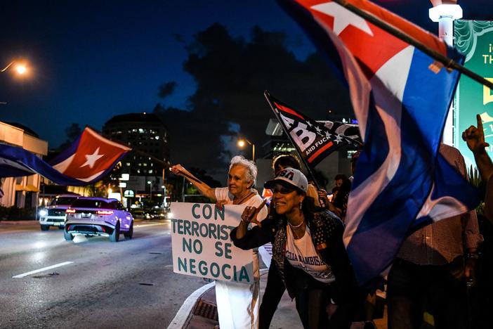 Holding a sign reading "No negotiation with terrorists," Cuba supporters protest in Miami ahead of bilateral talks between the U.S. and Cuba in Washington in April.