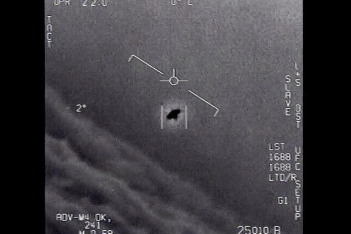 In this image from 2015 video provided by the Department of Defense, an unexplained object is seen as it is tracked soaring high along the clouds, traveling against the wind.