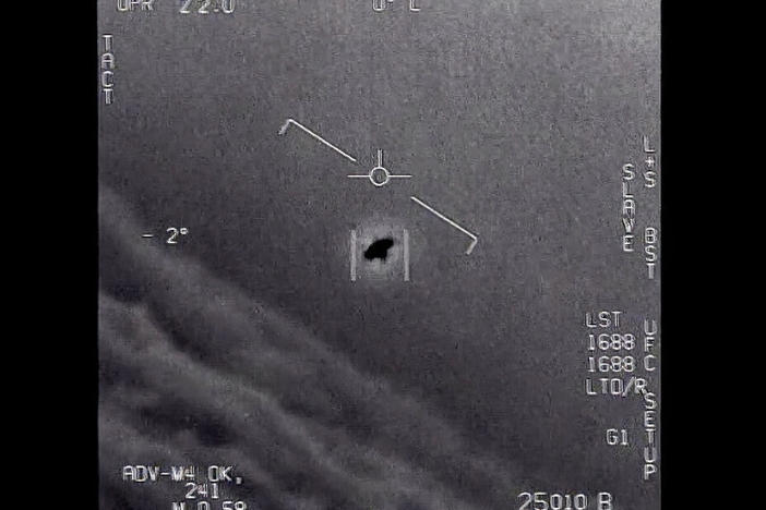 In this image from 2015 video provided by the Department of Defense, an unexplained object is seen as it is tracked soaring high along the clouds, traveling against the wind.