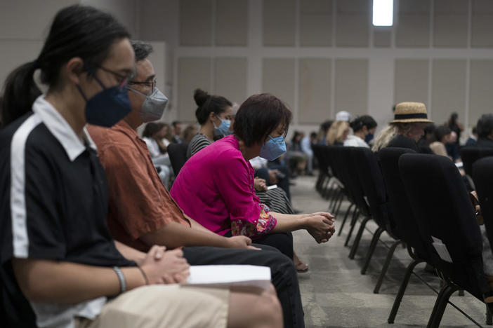 People pray during a prayer vigil in Irvine, Calif., Monday, May 16, 2022. The vigil was held to honor victims in Sunday's shooting at Geneva Presbyterian Church in Laguna Woods, Calif.