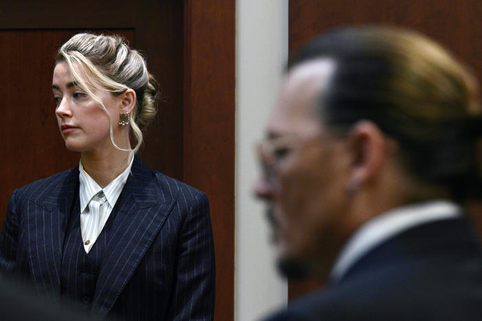 Actors Amber Heard and Johnny Depp watch the jury arrive in the courtroom at the Fairfax County Circuit Court in Fairfax, Va. on Tuesday.