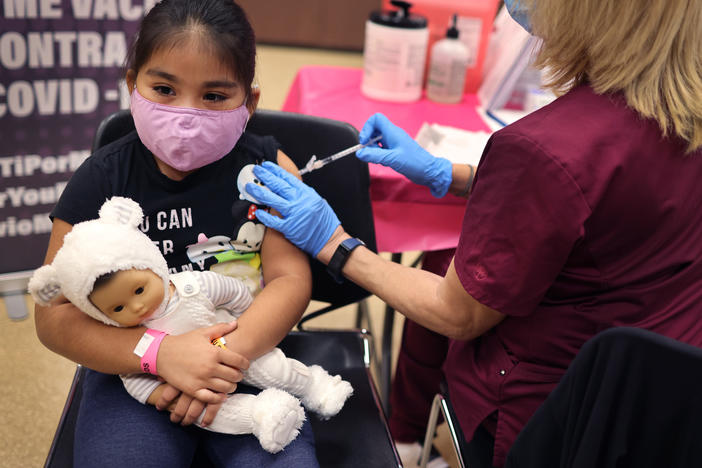 First grader Rihanna Chihuaque, 7, receives a COVID-19 vaccine at Arturo Velasquez Institute in Chicago last November.