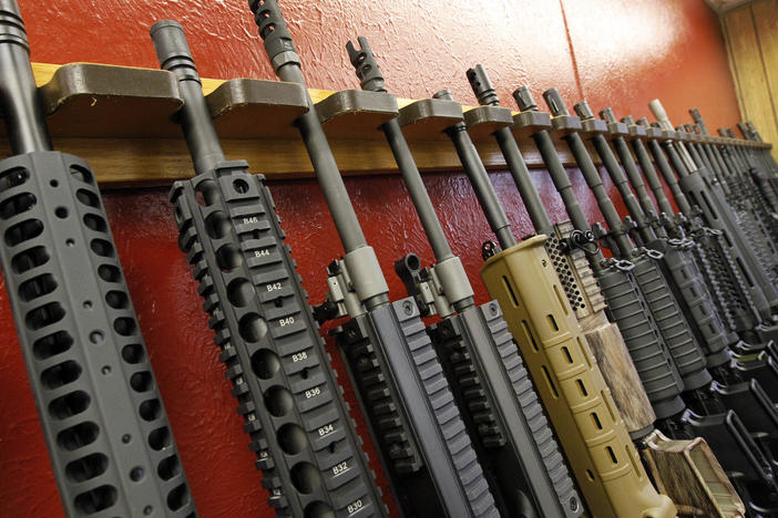 A row of rifles for sale is on display at a gun shop in Aurora, Colo., on July 20, 2012. The mass shooting in Buffalo, N.Y., has prompted questions about the effectiveness of "red flag laws" passed in 19 states and the District of Columbia.