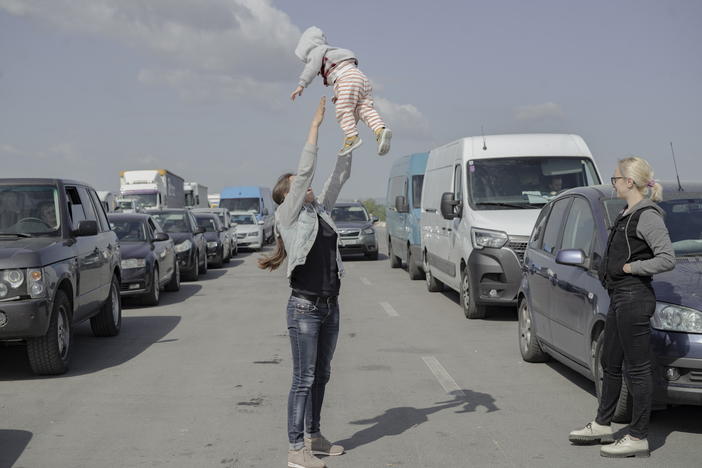 Ukrainians wait in a miles-long jam full of trucks, buses and cars to cross to the border at Medyka, Poland.