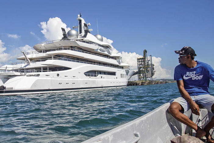 Boat captain Emosi Dawai looks at the super-yacht Amadea where it is docked at the Queens Wharf in Lautoka, Fiji, on April 13, 2022. The super-yacht that American authorities say is owned by a Russian oligarch previously sanctioned for alleged money laundering has been seized by law enforcement in Fiji, the U.S. Justice Department announced May 5.