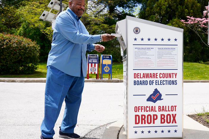 A voter drops off his mail ballot for the 2022 Pennsylvania primary elections in Newtown Square, Pa., on May 2. The state's Supreme Court has ruled in a lawsuit challenging the constitutionality of a state law that expanded mail-in voting.