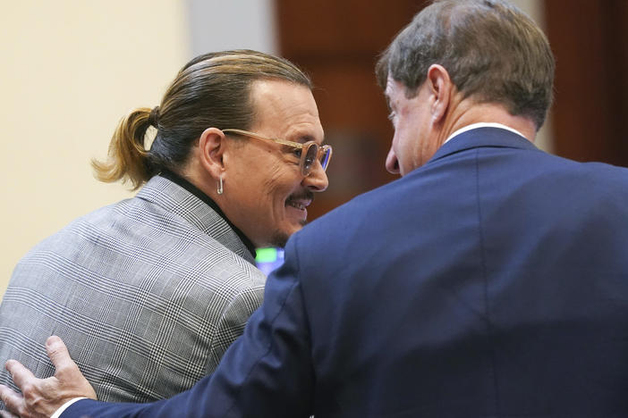 Actor Johnny Depp speaks with his legal team in the courtroom at Fairfax County Circuit Court in Fairfax, Va. on Thursday.