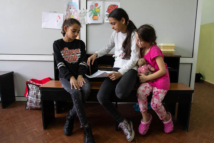 Raise Grigorievna Dreama's daughters Malina (left) and Ramina (center) and her granddaughter Monica (right) sit in their room at a temporary Chisinau housing center for refugees, mostly hosting people from the Roma community and other minority groups from Ukraine, in April.