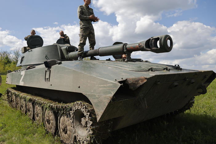 Russian-backed Donetsk militia fighters man "Gvozdika" (Carnation) self-propelled artillery vehicles to fire toward a Ukrainian army position outside Donetsk, in territory held by the separatist Donetsk government in eastern Ukraine, Friday. Fighting has intensified in the Donbas region this week.