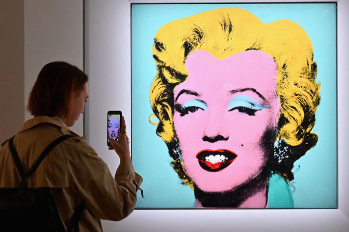 A woman takes a photo of Andy Warhol's 'Shot Sage Blue Marilyn' on April 29 during Christie's 20th and 21st Century Art press preview in New York City.