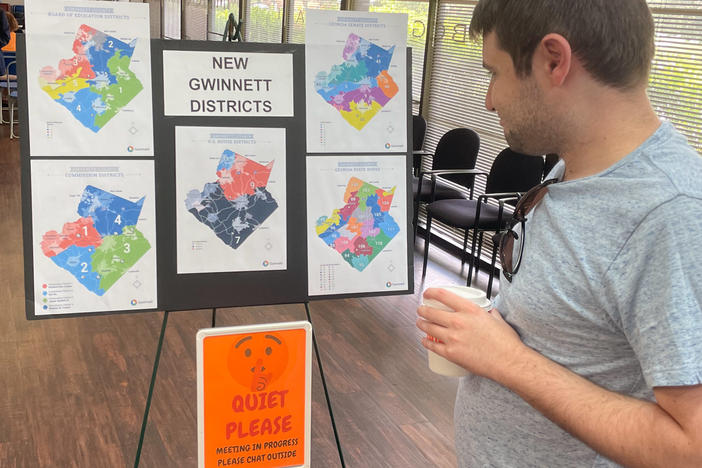 A man looks at newly drawn congressional districts for Gwinnett County, Ga., at a meeting of county Democrats this month.