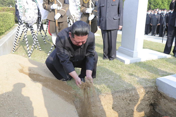 In this photo provided by the North Korean government, North Korean leader Kim Jong Un covers the coffin of Hyon Chol Hae, marshal of the Korean People's Army, with earth at a cemetery in Pyongyang, North Korea Sunday, May 22, 2022. The content of this image cannot be independently verified.