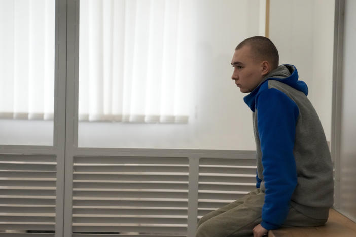 Russian Sgt. Vadim Shishimarin waits for the start of a court hearing in Kyiv, Ukraine, on Monday. Judges went on to sentence him to life in the first war crimes trial since Russia's full-scale invasion of Ukraine.