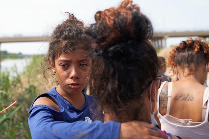 A young migrant cries after illegally crossing the Rio Grande River with her family in Eagle Pass, Texas, on May 22, 2022.