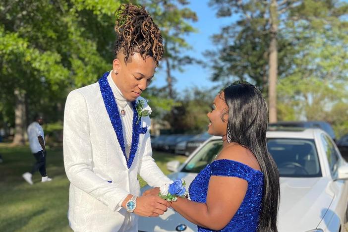 Cameron Frazier and Gabrielle Cistrunk. Cameron wore an embroidered white suit, with blue sequins on the lapel and the bottom of the legs. His shoes featured blue sequin trim.