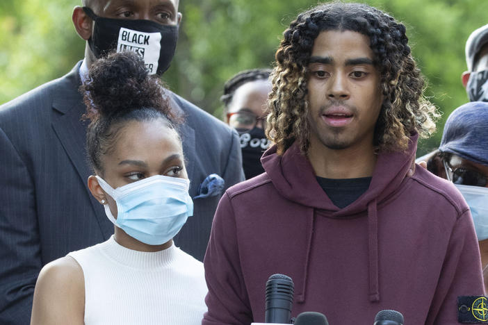 Taniyah Pilgrim and Messiah Young address the press at Morehouse College in Atlanta. Prosecutors filed charges against six officers involved in the couple's arrest.