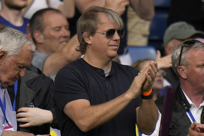 American businessman Todd Boehly, center, applauds as he attends the English Premier League soccer match between Chelsea and Watford at Stamford Bridge stadium in London, Sunday, May 22, 2022.
